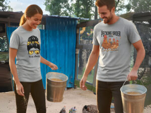 people feeding chickens while wearing Teez Farms shirts